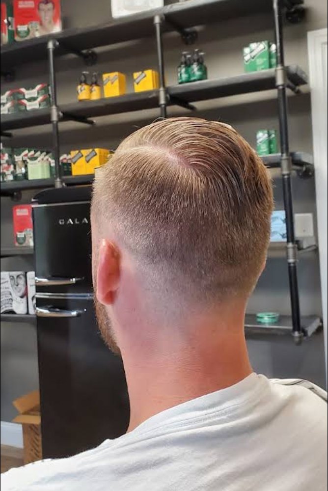 Skin fade with a textured top, from behind